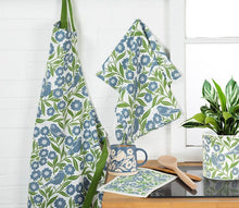Load image into Gallery viewer, Wide-base blue stoneware mug with ivory bird, leaves, and floral motif and a natural clay base, shown on a white background
