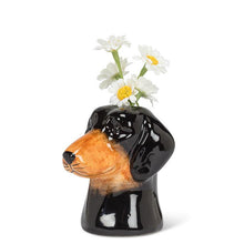 Load image into Gallery viewer, Ceramic dachshund head bud vase in glossy black and brown with a small opening at the top, shown on a white background