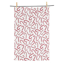 Load image into Gallery viewer, Red and white cotton kitchen towel with allover candy cane print hanging on a clothesline