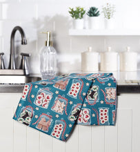 Load image into Gallery viewer, Blue Christmas kitchen towel with festive cookie jar pattern styled in a holiday kitchen