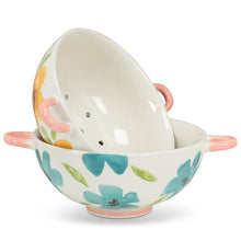 Load image into Gallery viewer, Ivory stoneware colander with yellow floral pattern, green leaves, and pink handles
