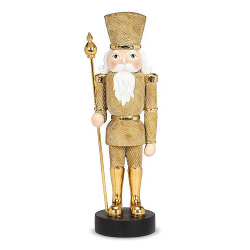 Gold nutcracker figurine with staff on black base