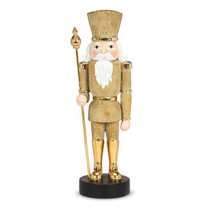 Gold nutcracker figurine with staff on black base