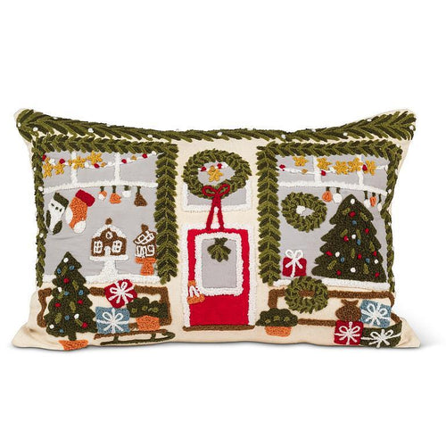 Rectangular lumbar pillow with tufted holiday storefront scene—garlands, wreaths, and gifts in warm neutrals, red, and green.