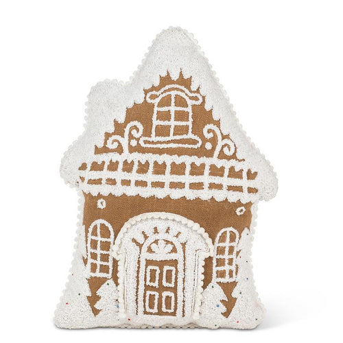 Gingerbread house–shaped pillow with white tufted icing details.