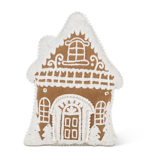 Gingerbread house–shaped pillow with white tufted icing details.