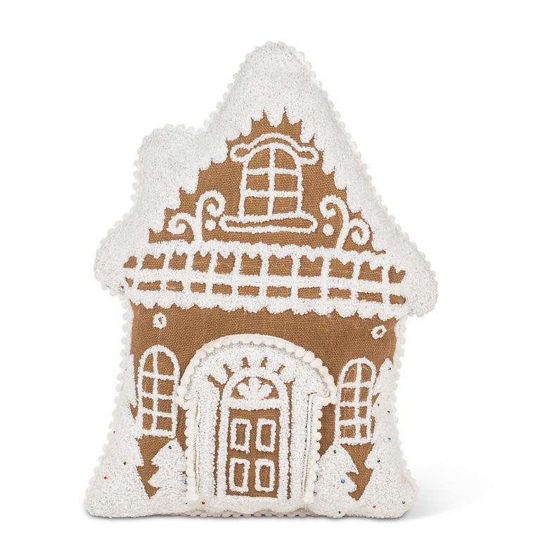 Gingerbread house–shaped pillow with white tufted icing details.