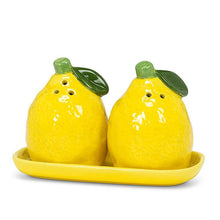 Load image into Gallery viewer, Ceramic lemon-shaped salt and pepper shaker set with green leaf details on a matching yellow tray
