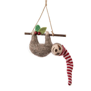 Snowcap Sloth Ornament—felt sloth hanging from a twig with striped knit hat, leaves and berries