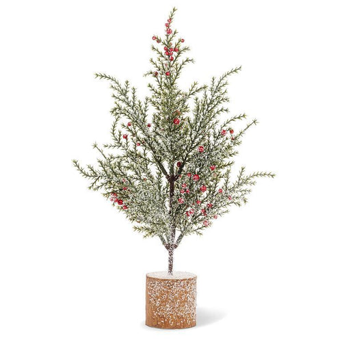 Snowy pine with red berries on a circular wood-slice base