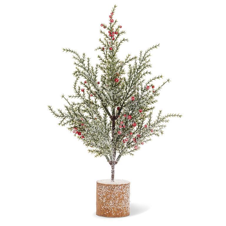 Snowy pine with red berries on a circular wood-slice base