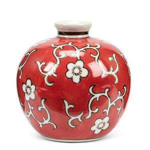 Small round ceramic floral ball vase with a glossy red and brown finish, styled as shelf or tabletop